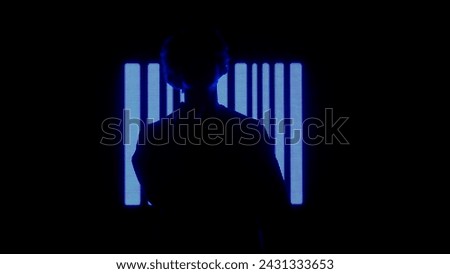 Male against big digital wall. Man silhouette posing in front of digital screen wall with neon symbols background in dark club.
