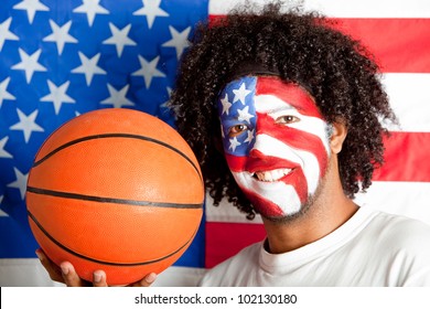 Male American Basketball Fan With The USA Flag Painted On His Face