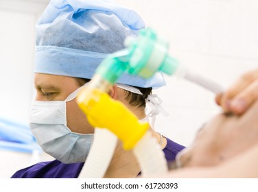 Male Anesthesiologist With Patient Working In Operation Room