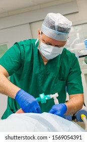 Male Anesthesiologist Working In Operation Room