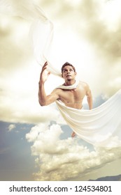 Male Angel Flying On Sky Background.