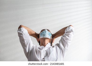 Male Angry. Upset Asian Young Man Wearing A Face Mask Alone At A Home Office Having Problems Or Bad Time Financial. Trouble, Stress, Depression, Illness, And Suffering In Covid-19 Coronavirus Concept.