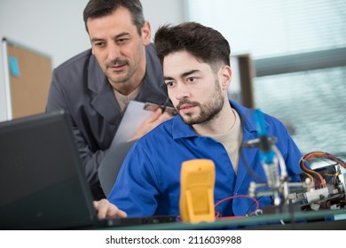 Male Apprentice Is Repairing A Machine