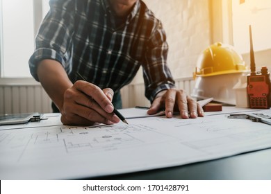 Male architect or engineer working at home drawing the construction project. - Powered by Shutterstock