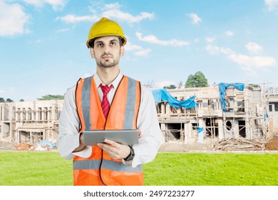 Male architect holding a digital tablet thinking of something - Powered by Shutterstock