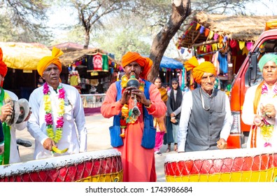 Male Artists Playing Regional Folk Music With Ethnic White Dress And Colorful Turban At Surajkund Craft Fair, Faridabad, Haryana, India, February 2020
