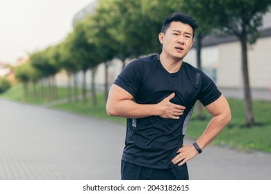 Male Asian Athlete, Has Chest Pain Fitness In The Park And Running, Heart Aches After Cardio Exercise