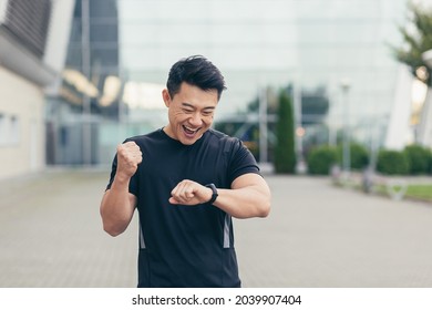 Male Asian Athlete On A Morning Run Rejoices At The Achieved Result, Smiles