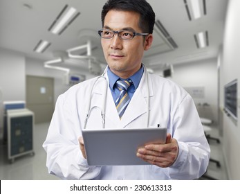 Male Asian Doctor With Tablet Computer.