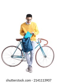 Male Asian Student With Copybook, Backpack And Bicycle On White Background