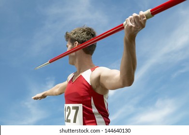 Male athlete about to throw javelin against the sky - Powered by Shutterstock