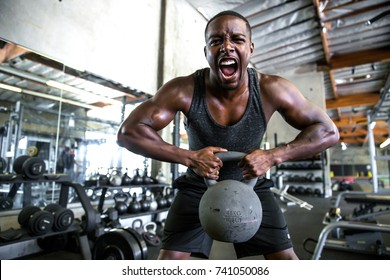 Male Athlete Body Builder Champion In Extreme Heavy Weight Lifting Gym Emotion And Grit