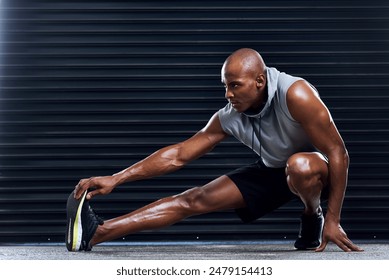 Male athlete, exercise and stretching leg with hand for sports, workout and fitness in gym. Healthy man, challenge and cardio routine for wellness, muscle and strength training for mental wellbeing - Powered by Shutterstock