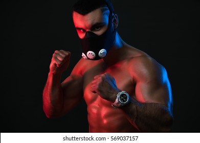 Male Athlete Exercising In Training Mask