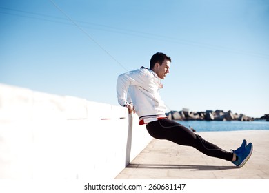 male athlete lifting body with arms outdoors - Powered by Shutterstock