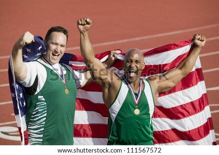 Male athlete with medal and American flag on track and field