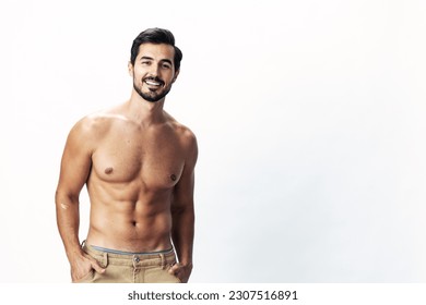 Male athlete model with naked torso and packs of abs sporty on white isolated background, trendy clothing style, copy space, space for text