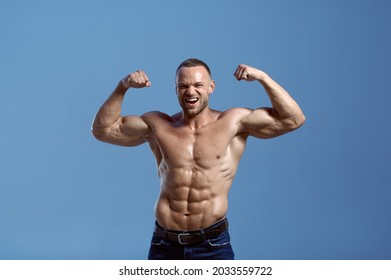 Male athlete with muscular body shows his power