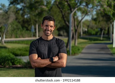 Male Athlete On The Street In The Park, Posing For A Corporate Portrait, Close-up, For Promotion As A Fitness Trainer. Crossed Arms