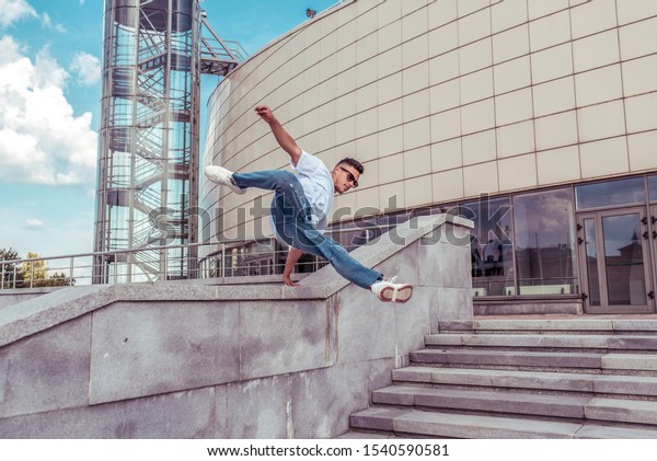 Male athlete, runs and jumps in jump, summer\
city, hip hop style, breakdancer. Free space for motivation text.\
Active youth lifestyle, modern fashionable hipster, street dancer.\
Fitness movement