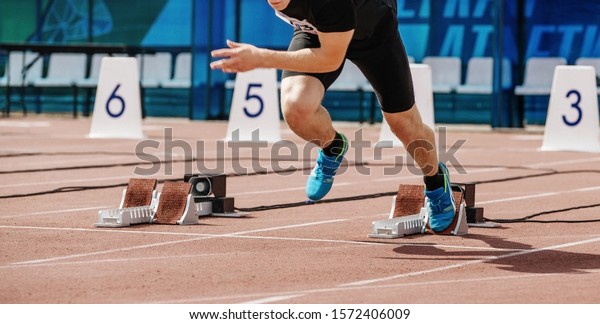 male athlete sprinter start 100 meters at\
athletics competition