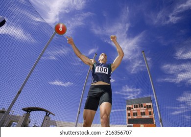 Male athlete throwing discus, low angle view - Powered by Shutterstock