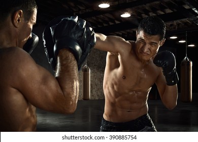 Male Athlete Training Boxing Skills At Gym