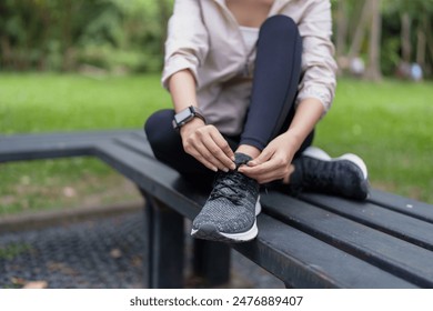 Male athlete tying shoelaces at the park
 - Powered by Shutterstock