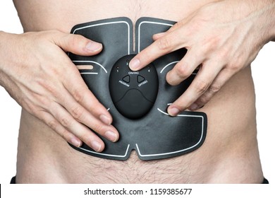 Male athlete wearing a electric ab muscle stimulator doing abs exercise isolated
