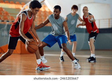 Male athletes playing basketball match in school gymnasium. - Powered by Shutterstock