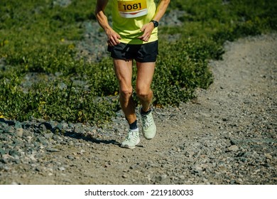 Male Athletes Running Uphill Race