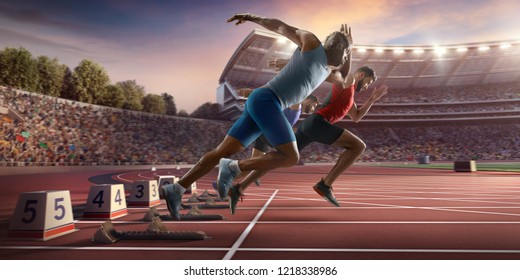Male athletes sprinting. Three men in sport clothes run at the running track in professional stadium