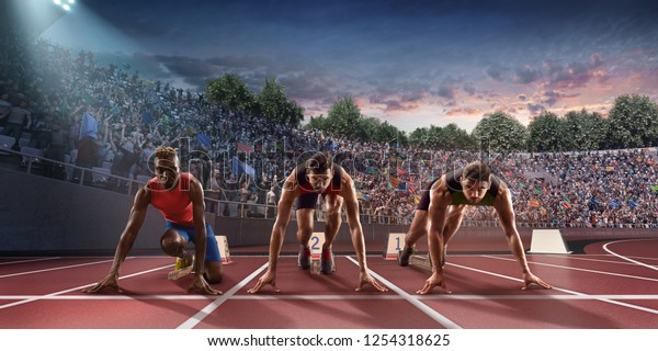 Male athletes sprinting. Three men in sport clothes\
on starting line prepares to run at the running track in\
professional stadiumRunning Track, Running, Sports Race, athletics,\
Sports Track, run, Trac