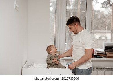 Male Babysitter Prepares The Child For Sleep In The Middle Of The Day, Smiles And Explains To The Child That It's Time To Sleep