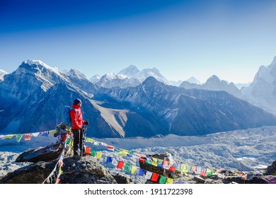 Male backpacker enjoying the view on mountain walk in Himalayas. Travel, adventure, sport concept