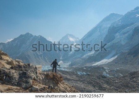 Male backpacker enjoying the view on mountain walk in Himalayas. Everest Base Camp trail route, Nepal trekking, Himalaya tourism. Travel, adventure, sport concept