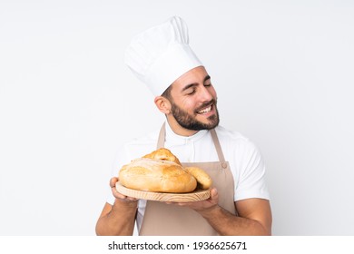 Male Baker Holding A Table With Several Breads Isolated On White Background