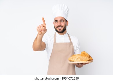 Male baker holding a table with several breads isolated on white background touching on transparent screen - Powered by Shutterstock