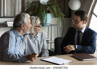 Male bank specialist worker consult mature man and woman spouses about elderly health insurance. Middle-aged Caucasian couple clients customers have meeting with real estate agent or broker. - Powered by Shutterstock