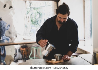 Male Barista Preparing Fresh Espresso In Coffee Maker For Customer In A Fancy Coffee Shop. Cafe Owner Serving A Client At The Coffee Shop.