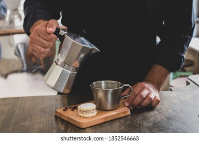 Male Barista Preparing Fresh Espresso In Coffee Maker For Customer In A Fancy Coffee Shop. Cafe Owner Serving A Client At The Coffee Shop.