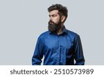 Male beard and mustache. Stylish bearded man in a blue shirt on a gray background. Bearded man, stylish hairstyle, beard. Perfect beard. Bearded man, stylish hairstyle. Man portrait isolated.