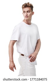 Male Beauty, Fashion. Portrait Of A Handsome Young Man With Blond Hair Posing At Studio In Casual White Clothes On A White Background. Summer Style.