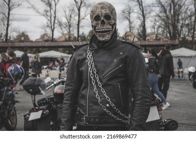 A Male Biker In A Leather Biker Jacket And A Skeleton Mask, Dressed As A Ghost Rider. The Opening Of The Biker Season. A Party Of Rockers And Bikers.