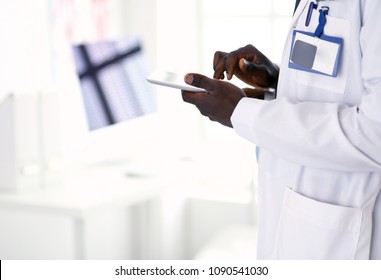 Male Black Doctor Worker With Tablet Computer Standing In Hospital