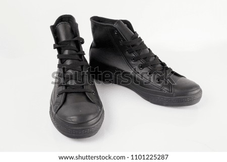 Male black leather sneaker on white background, isolated product, comfortable footwear.