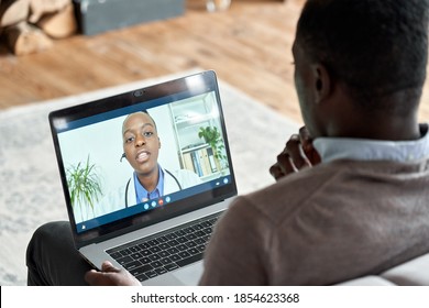 Male black patient on conference video call with female african doctor. Virtual therapist consulting young man during online appointment on laptop at home. Telemedicine chat, telehealth concept.