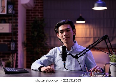 Male Blogger Filming Live Vlog Show With Podcast Equipment At Home, Using Audio Station And Recording Video. Broadcasting Livestream With Microphone, Sound Production For Channel.