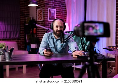 Male Blogger Filming Video With Podcast Equipment In Studio, Recording Online Vlog And Hosting Talk Show At Station. Content Creator Using Live Broadcast On Entertainment Channel.