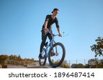 Male bmx biker, jump in action, skatepark